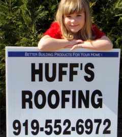 girl with huffs roofing sign